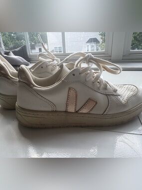 Veja white sneakers with metallic gold V logo